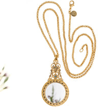 Load image into Gallery viewer, Agape - Mirror Medallion Long Necklace. Gold Plate and hand Enameled with Bohemian Crystal Accents. Length 36". OPosite Side Has an Incased Crystal Mirror.