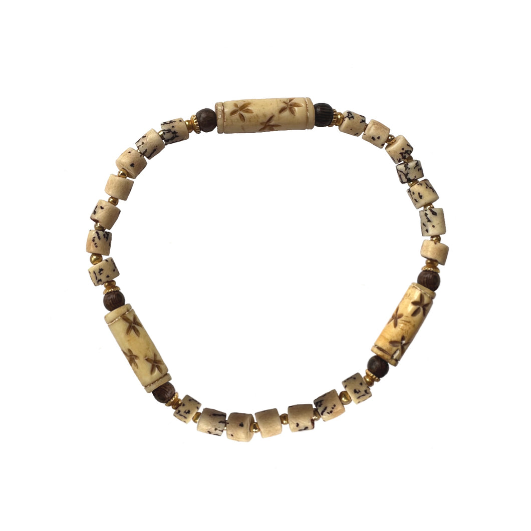 Urban Boho - Bellatrix Stretch Bracelet is designed with hand carved natural Bone beads and accented with brown wood and 24K Gold plated beads | Manukyan Design Studio