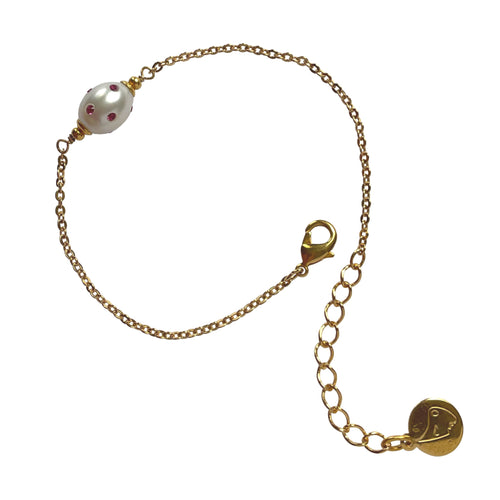 Natural, high quality Freshwater Pearl in Cream White color is inlaid with Bohemian Crystals in Fuchsia, finished with 24K Gold plated sparkly link chain. The bracelet measures 7