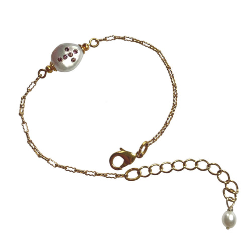 Natural, high quality Freshwater Pearl in Cream White color is inlaid with Bohemian Crystals in Lilac, finished with 24K Gold plated corrugated link chain. The bracelet measures 6.5