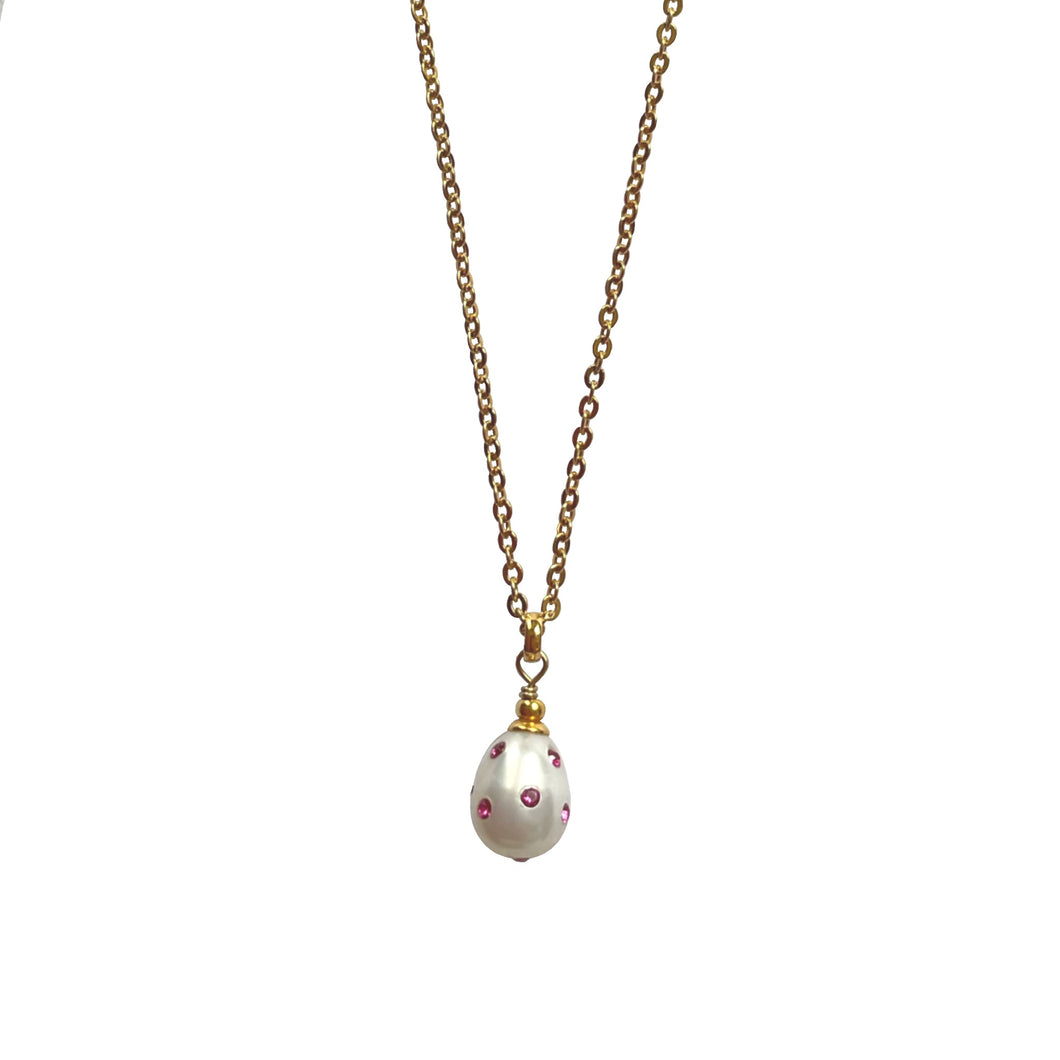 Natural, high quality Freshwater Pearl pendant in Cream White color is inlaid with Bohemian Crystals in Fuchsia color, suspended from 24K Gold plated sparkly link chain, measuring 18