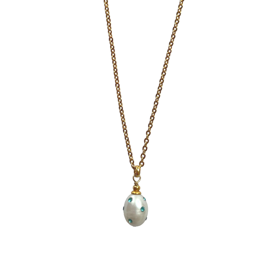 Natural, high quality Freshwater Pearl pendant in Cream White color is inlaid with Bohemian Crystals in Turquoise color, suspended from 24K Gold plated sparkly link chain, measuring 18