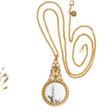 Load image into Gallery viewer, Agape - Mirror Medallion Long Necklace. Gold Plate and hand Enameled with Bohemian Crystal Accents. Length 36&quot;. OPosite Side Has an Incased Crystal Mirror.
